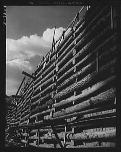 Tennessee Valley Authority. Construction of Douglas Dam. A log cofferdam at TVA's new Douglas Dam on the French Broad River. This dam will be 161 feet high and 1,682 feet long, with a 31,600 acre reservoir area extending forty-three miles upstream. With a useful storage capacity of approximately 1,3