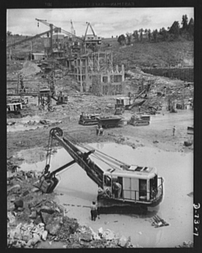 Tennessee Valley Authority. Construction of Douglas Dam. Excavating within the cofferdam at TVA's new Douglas Dam on the French Broad River. This dam will be 161 feet high and 1,682 feet long, with a 31,600 acre reservoir area forty-three miles upstream. With a useful storage capacity of approximate
