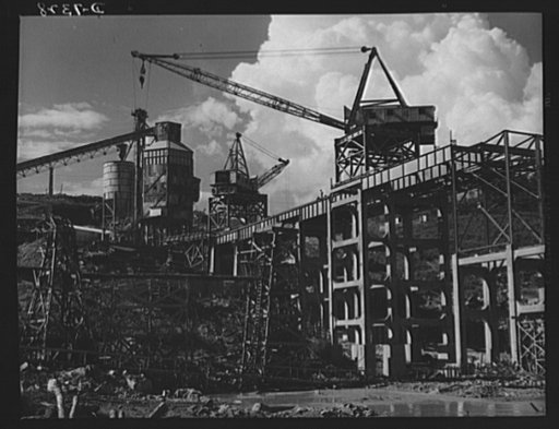 Tennessee Valley Authority. Construction of Douglas Dam. A concrete mixer and the cranes that serve it at TVA's new Douglas Dam on the French Broad River. This dam will be 161 feet high and 1,682 feet long, with a 31,600 acre reservoir area extending forty-three miles upstream. With a useful storage