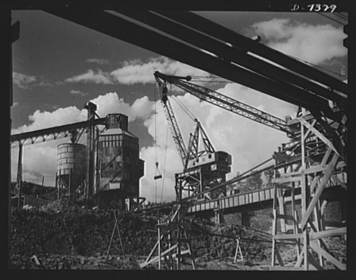 Tennessee Valley Authority. Construction of Douglas Dam. A concrete mixer and the cranes that serve it at TVA's new Douglas Dam on the French Broad River. This dam will be 161 feet high and 1,682 feet long, with a 31,600 acre reservoir area extending forty-three miles upstream. With a useful storage