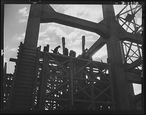 Tennessee Valley Authority. Construction of Douglas Dam.  Removing concrete forms at TVA's new Douglas Dam on the French Broad River. This dam will be 161 feet high and 1,682 feet long, with a 31,600 acre reservoir area extending forty-three miles upstream. With a useful storage capacity of approxim