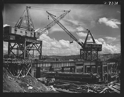 Tennessee Valley Authority. Construction of Douglas Dam.  Cranes serving the construction crews at TVA's new Douglas Dam on the French Broad River. This dam will be 161 feet high and 1,682 feet long, with a 31,600 acre reservoir area extending forty-three miles upstream. With a useful storage capaci