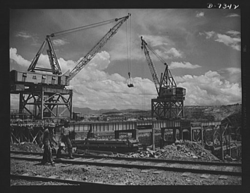 Tennessee Valley Authority. Construction of Douglas Dam.  Cranes that serve construction crews at TVA's new Douglas Dam on the French Broad River. This dam will be 161 feet high and 1,682 feet long, with a 31,600 acre reservoir area extending forty-three miles upstream. With a useful storage capacit