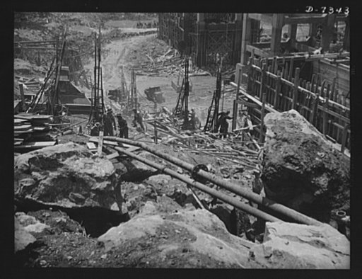 Tennessee Valley Authority. Construction of Douglas Dam.  Drilling and cleaning bed rock at a dam site is much the same as filling a tooth. On this base will rise TVA's new Douglas Dam on the French Broad River. This dam will be 161 feet high and 1,682 feet long, with a 31,600 acre reservoir area ex