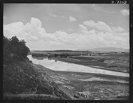 Tennessee Valley Authority. Construction of Douglas Dam. Looking upstream from TVA's new Douglas Dam on the French Broad River. This dam will be 161 feet high and 1,682 feet long, with a 31,600 acre reservoir area extending forty-three miles upstream. With a useful storage capacity of approximately 
