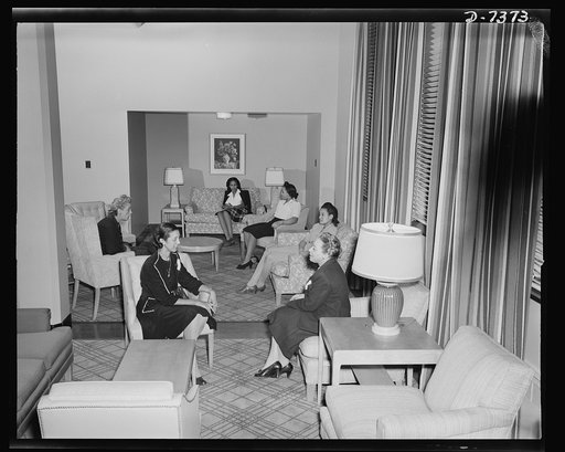 Government hotel for Negro women war workers. Administrative staff members of the 760,000 dollar Lucy D. Slowe Residence Hall, first government constructed hotel for Negro women war workers in Washington, D.C. are shown in one of the nooks of the spacious lounge of the hotel. Reading to the left (cl