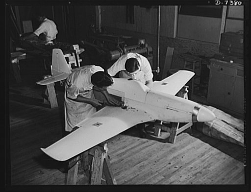 Production. Airplane manufacture, general. Model makers prepare accurately scaled miniatures of planes built at the Inglewood, California plant of North American Aviation, Incorporated. Here an experimental model of the P-51 ("Mustang") is being finished for wind tunnel and other tests. This plant p