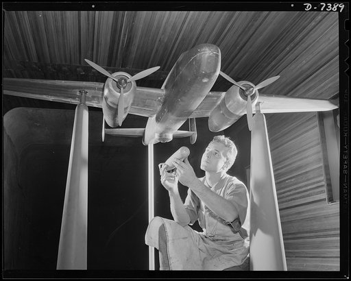 Production. Airplane manufacture, general. An experimental scale model of the B-25 plane is prepared for wind tunnel tests in the Inglewood, California plant of North American Aviation, Incorporated.  The model maker holds an exact miniature reproduction of the type of bomb the plane will carry. Thi