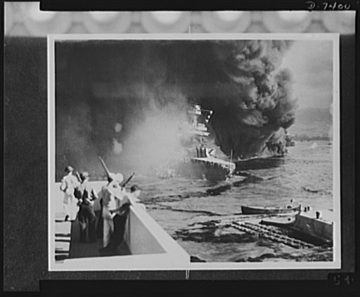 Pearl Harbor bombing. California hit. Battered by aerial bombs and torpedoes, the USS California settles slowly into the mud and muck of Pearl Harbor. Clouds of black, oily smoke pouring up from the California and her stricken sister ships conceal all but the hull of the capsized USS Oklahoma at the