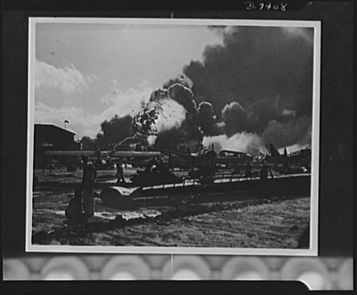 Pearl Harbor bombing. Naval air station. This is the wreckage-strewn naval air station at Pearl Harbor following one of the Japanese sneak attacks on the morning of December 7, 1941. In the background, an explosion sends a mass of flames and smoke high in the sky