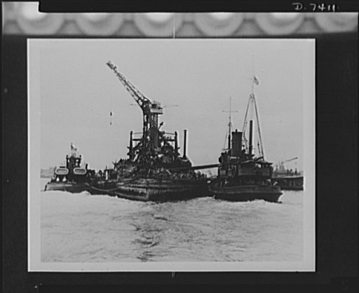 Pearl Harbor bombing. USS California. The 32,000 ton battleship, USS California is shown being towed to drydock at Pearl Harbor, T.H. This ship was raised from her shallow resting place by means of cofferdams