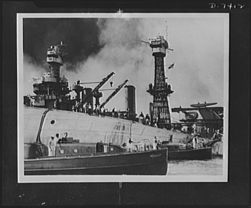 Pearl Harbor bombing. USS Oklahoma. Rescue crews are shown here working on the upturned hull of the 29,000 ton battleship USS Oklahoma, which capsized in Pearl Harbor after being blasted by Japanese warplanes. Holes were burned through the hull to permit the rescue of some of the men trapped below. 