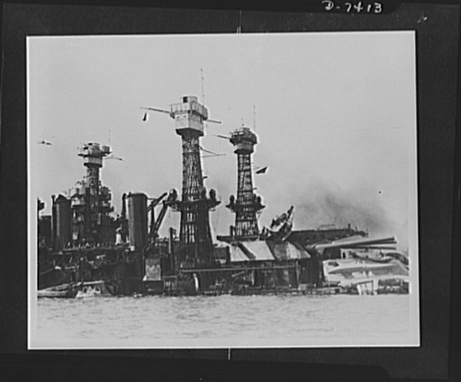 Pearl Harbor bombing. After the fire. Battered by aerial torpedoes and bomb hits, the 31,800 ton USS West Virginia (nearest ship) rests on the bottom of Pearl Harbor. Fire following the explosions as well as oil flames from the nearby sunken USS Arizona added extensively to the damage. Noted the wre