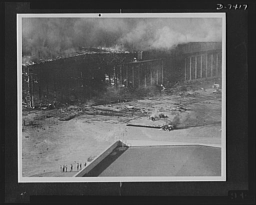 Pearl Harbor bombing. Hangar fire. Japanese bombs wrecked and fired this hangar at the U.S. naval air station, Pearl Harbor, in addition to causing extensive damage to planes on the apron and runways, several of which may be seen in the foreground