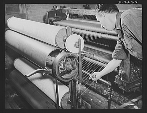 Discarded stockingss go to war. Here's what comes from your old silk stockings. Silk thread to be used in making powder bags is produced from discarded hose which have been subjected to various processes. Here, the silk thread emerges from a breaker machine which spins the bleached material into thi