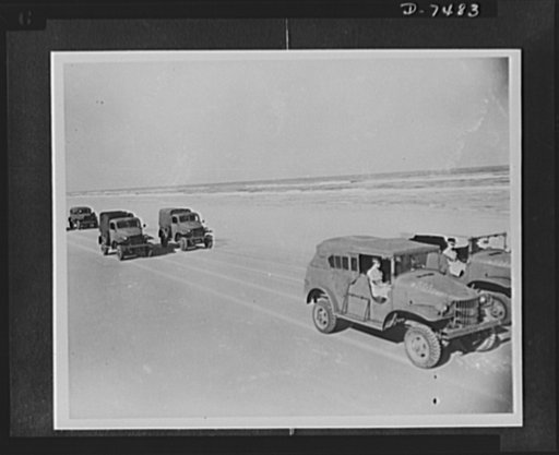 Women's Army Auxiliary Corps. WAAC motor convoy group takes refresher course before taking up instruction duties. In double file the trucks roll along the hard packed sands of Daytona Beach, Florida