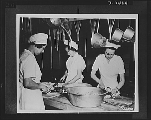Women's Army Auxiliary Corps. Some WAACs go right to the mess kitchen after march drill, as these three shown preparing food. Fort Des Moines, Iowa, 1942