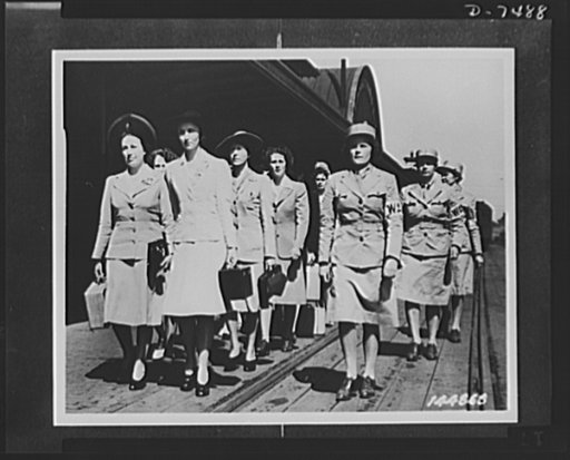 WAACs (Women's Army Auxiliary Corps). Newly-arrived recruits being marched away from railway station at Fort Des Moines, Iowa