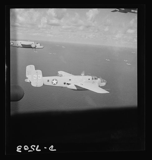 American wings over Africa. A B-25 medium bomber (foreground) is escorted by a group of A-20 light bombers serving as fighter ships over the North African desert. Their objective was an advance Axis headquarters
