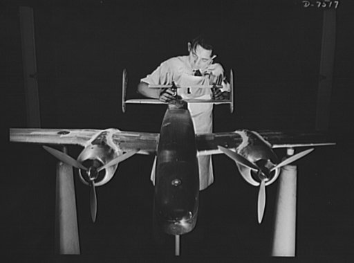 Production. Airplane manufacture, general.  Preparing an experimental scale model of the B-25 bomber for the wind tunnel tests in the Inglewood, California, plant of North American Aviation, Incorporated. The model maker is adjusting the empennage to its correct position. This plant produces the bat