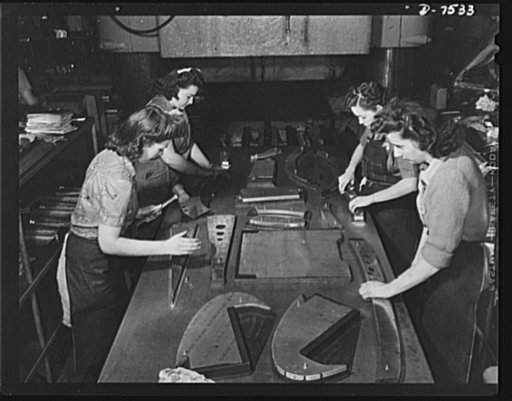 Production. Airplane manufacture, general. Sheet metal plane parts, previously cut on a router are pressed to all the required shapes on Masonite dies in a 3,000 ton hydraulic press in the Inglewood, California, plant of North American Aviation, Incorporated. Four crews of girls, one at each side, f