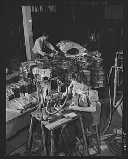 Production. Airplane manufacture, general. A woman employee operated a pneumatic numbering machine in the sheet metal department of North American Aviation, Incorporated at Inglewood, California. All items are given index numbers. This plant produces the battle-tested B-25 ("Billy Mitchell") bomber,