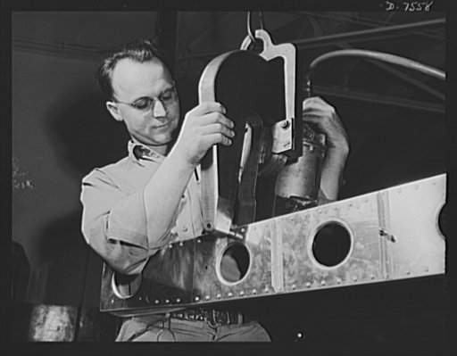Production. Airplane manufacture, general. A squeeze riveted in operation at the Inglewood, California, plant of North American Aviation, Incorporated. The operator works the machine as he assembles parts for the horizontal and vertical stabilizers for the control surfaces of bomber and fighter plan