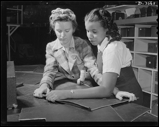 Production. Airplane manufacture, general. Two women employees work together with power shears at the Inglewood, California, plant of North American Aviation, Incorporated. They are cutting sheet metal sections that will be formed into parts for bomber and fighter planes. This plant produces the bat