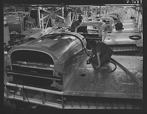 Production. Airplane manufacture, general. A partial view of one of the overhead conveyor lines at North American Aviation's plant at Inglewood, California. This plant produces the battle-tested B-25 ("Billy Mitchell") bomber, used in General Doolittle's raid on Tokyo, and the P-51 ("Mustang") fight