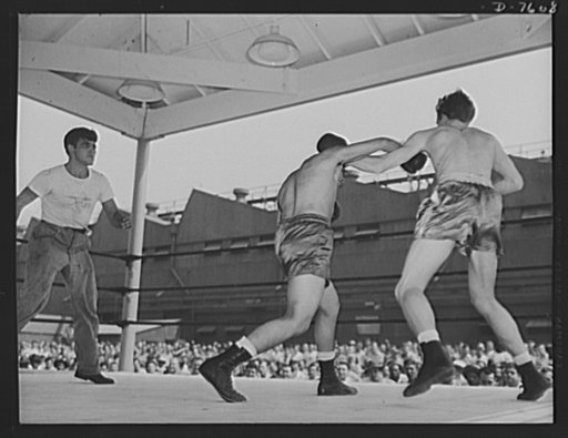 Production. Airplane manufacture, general. Two employees of the North American Aviation plant at Inglewood, California, entertain their fellow workers with a boxing match during the lunch period recreation program. This plant produces the battle-tested B-25 ("Billy Mitchell") bomber, used in General
