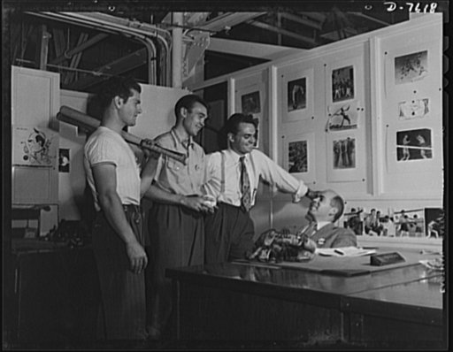Production. Airplane manufacture, general. A group of employees at the Inglewood, California, plant of North American Aviation, discuss the evening inter-department softball game with Ken Kellough, recreation director. The recreation department sponsors softball, baseball, basketball, tennis, swimmi