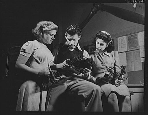 Victory Corps, tomorrow's defenders of liberty. Learning to operate their cameras, these members of the Washington High School Victory Corps in Los Angeles, are being trained for war work. To supply technical training in various skills relating to the war effort is the main object of Victory Corps o