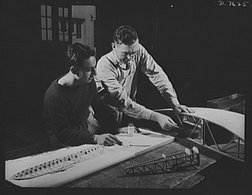 Victory Corps, tomorrow's defenders of liberty. Model airplane construction to meet Navy specifications requires a technical knowledge of plane parts. Instructor Oren Johnston shows Victory Corps member John Lopez, of Roosevelt High School in Los Angeles, California, the details of a plane that will