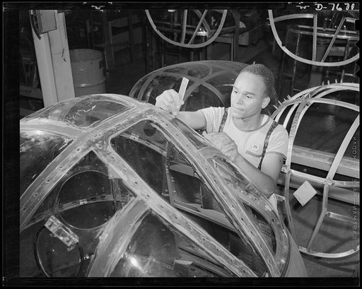 Production. B-25 "Billy Mitchell" bombers. This Negro employee at North American's Inglewood, California, plant, assembles the lucite windows for the bombardier's compartment of B-25 bombers. In addition to the battle-tested B-25 "Billy Mitchell" bomber, used in General Doolittle's raid on Tokyo, th