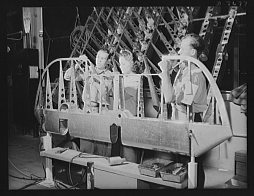 Production. B-25 "Billy Mitchell" bombers. The metal structure for a rudder on a B-25 bomber is assembled by North American employees in the control surface department at Inglewood, California. The part will next move to the covering department for its fabric cover. Women are fast taking the places 