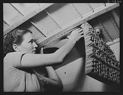 Production. B-25 "Billy Mitchell" bombers. A woman worker at North American's Inglewood, California, plant places rubber around wing tank spaces of B-25 bombers to prevent a vacuum. In addition to the battle-tested B-25 "Billy Mitchell" bomber, used in General Doolittle's raid on Tokyo, this plant p