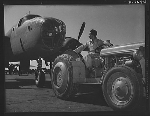 Production. B-25 "Billy Mitchell" bombers. A Negro employee at the flight ramp of North American's Inglewood, California, plant, tows a B-25 bomber into place. In addition to the battle-tested B-25 "Billy Mitchell" bomber, used in General Doolittle's raid on Tokyo, this plant produces the P-51 "Must