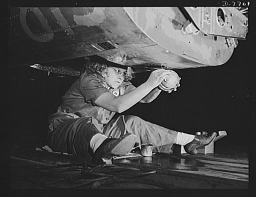 Production. B-25 "Billy Mitchell" bombers. A year ago this woman was keeping house; today she is doing her part in the war effort by helping build B-25 bombers at North American Aviation's Inglewood, California, plant. In addition to the battle-tested B-25 "Billy Mitchell" bomber, used in General Do