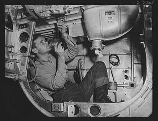 Production. B-25 "Billy Mitchell" bombers. Inside the nacelle of a B-25 bomber, this North American employee at Inglewood, California, assembles the hydraulic system for the landing gear. In addition to the battle-tested B-25 "Billy Mitchell" bomber, used in General Doolittle's raid on Tokyo, this p