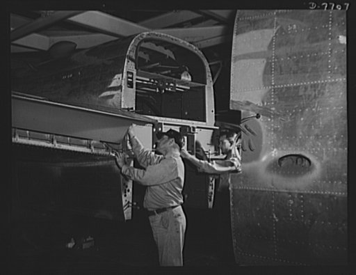 Production. B-25 "Billy Mitchell" bombers. The rear fuselage section of a B-25 bomber is attached to the center section before it moves to the final assembly conveyor line at the Inglewood, California plant of North American Aviation. In addition to the battle-tested B-25 "Billy Mitchell" bomber, us