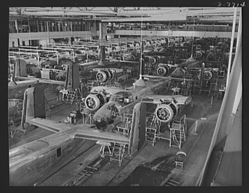 Production. B-25 "Billy Mitchell" bombers. Partial view of one of North American Aviation's B-25 bomber assembly lines at Inglewood, California. When the planes move out the door, they are ready for painting and flight tests. In addition to the battle tested B-25 "Billy Mitchell" bomber, used in Gen