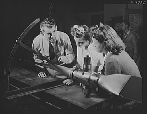 High school Victory Corps. Rudolph Angar, instructor, explains propeller characteristics to students in the aeronautics class at Washington High School, Los Angeles, California. Girls as well as boys are needed in airplane mechanics