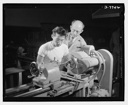 High school Victory Corps. Polytechnic High School, Los Angeles, California, teaches its students trades which fit them to help in the war program. This Chinese student is learning to operate a lathe