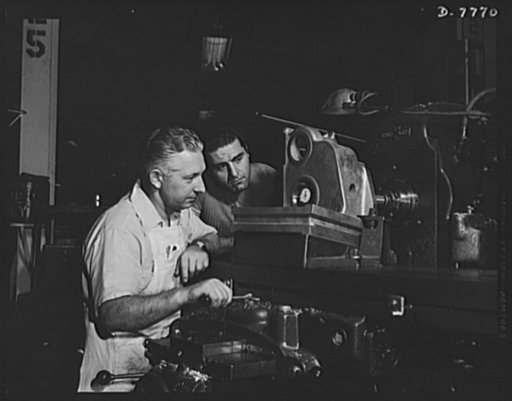 Production. P-51 "Mustang" fighter planes. The accuracy of a milling machine operation is checked by an inspector in a machine shop at the Inglewood, California, plant of the North American Aviation. The casting being milled will be part of the landing gear of a P-51 fighter plane. This plant produc