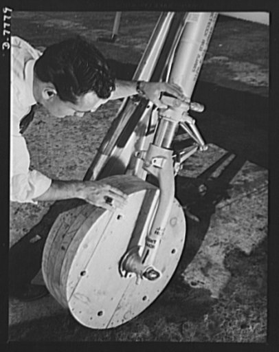 Production. P-51 "Mustang" fighter planes. An employee checks one of the temporary wooden wheels placed on a P-51 fighter on the North American flight training at the Inglewood, California, plant. Regular rubber tires are installed when the planes are ready for flight tests. This plant produces the 