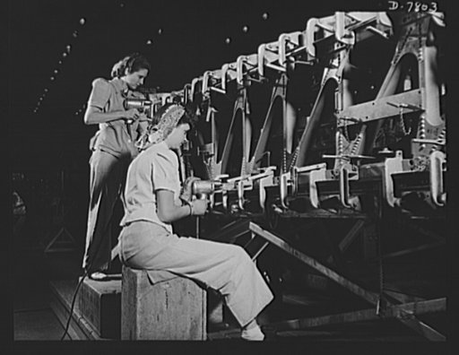 Production. B-17F heavy bombers. Careful and accurate girl technicians at the Long Beach, California, plant of Douglas Aircraft Company jig-drill a wing spar truss for a B-17F heavy bomber. Better known as the "Flying Fortress," the B-17F is a later model of the B-17, which distinguished itself in a