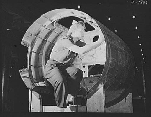 Production. B-17F heavy bombers. A girl worker at the Long Beach, California, plant of Douglas Aircraft Company, puts final touches on a nacelle of a B-17F heavy bomber before it is installed on a wing. Better known as the "Flying Fortress," the B-17F is a later model of the B-17, which distinguishe