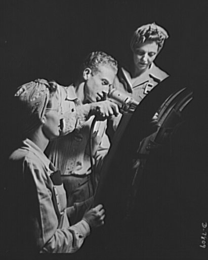 Production. B-17F heavy bombers. A foreman at the Long Beach, California, plant of Douglas Aircraft Company, instructs two new women employees in the technique of sheet metal assembly work. Better known as the "Flying Fortress," the B-17F is a later model of the B-17, which distinguished itself in a