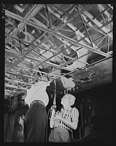 Production. B-17F heavy bombers. A lower skin section is riveted to the wing of a B-17F heavy bomber by women workers in the Long Beach, California, plant of Douglas Aircraft Company. Better known as the "Flying Fortress," the B-17F is a later model of the B-17, which distinguished itself in action 