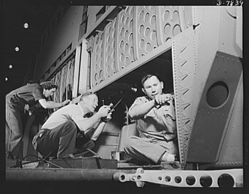 Production. Airplane maufacture, general. Inspectors at the Long Beach, California, plant of Douglas Aircraft Company, check all assembly work minutely to assure that dependable planes will go to our men at the front. Most important of the many types of aircraft made at the plant are the B-17F ("Fly